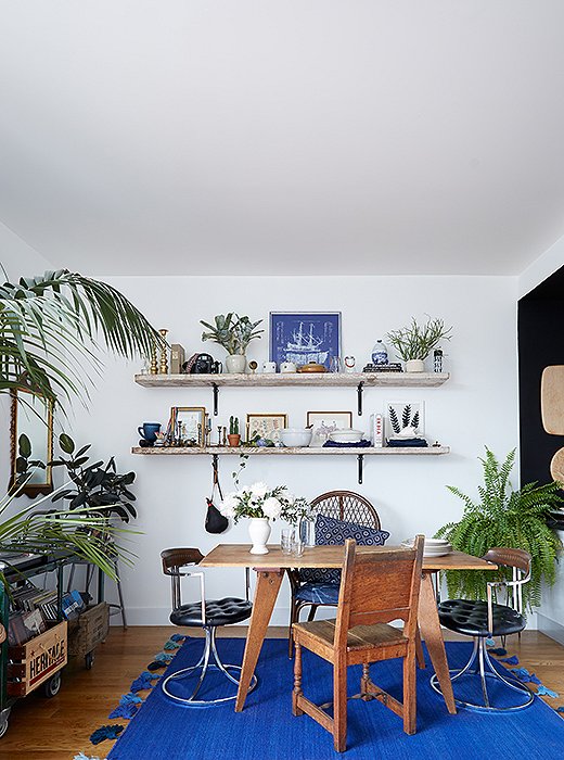 By limiting the cobalt blue to the rug, a pillow, and a few scattered items on the shelf—and not introducing additional colors—this room receives an injection of energy while retaining the simplicity of Danish ease. Photo by Manuel Rodriguez.
